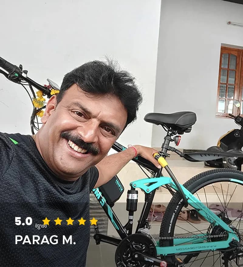 Parag M. beside his teal EMotorad electric cycle, rated 5.0 out of 5