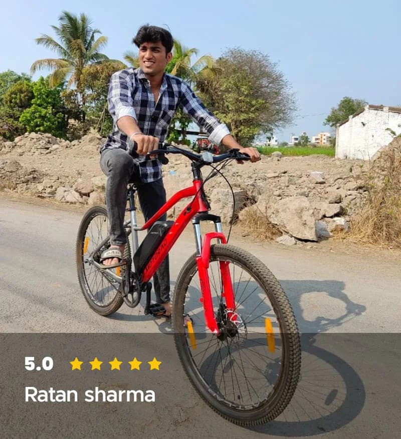 Ratan sharma riding his red EMotorad electric cycle on a country track, rated 5.0 out of 5