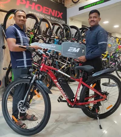 Sanskar Maroo with his EMotorad electric cycle